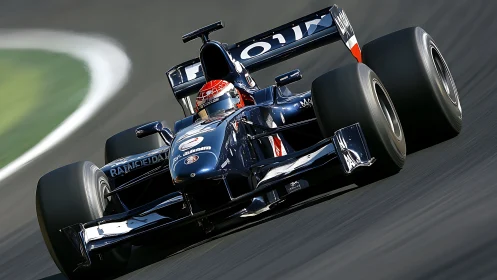 Formula race car on asphalt circuit under motion blur effect.