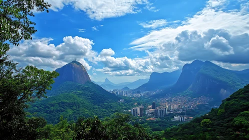 Tropical mountain skyline with urban valley under cumulus clouds.