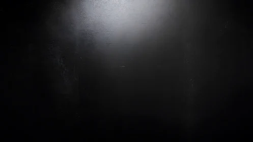 Dark textured wall surface shows central diffused lighting