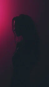 Side profile female silhouette in pink backlighting.