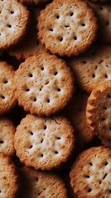 Golden crackers stacked together showing signature perforated holes.