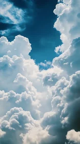 Towering cumulus clouds frame deep blue summer sky