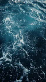 Ocean skin shivers in teal foam and restless silver light.