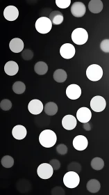 Defocused white circular light spots on dark background.