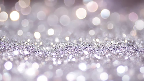 Silver glitter background with soft bokeh lights in dreamy style.