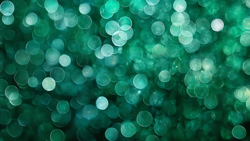 Green bokeh abstract background with soft glowing circles pattern.