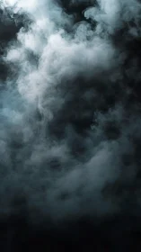 Soft swirling smoke drifts gently through a dark calm space