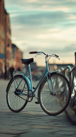Vintage Blue Bicycle Parked on Urban Brick Promenade.