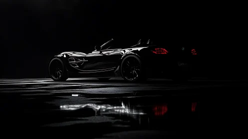 Black sports convertible in dramatic low key studio light.