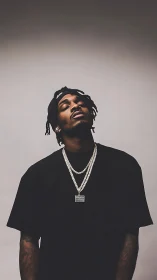 Relaxed portrait of a stylish man in soft studio light.