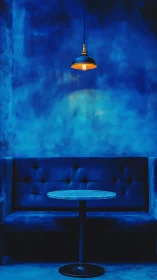 Moody blue lounge with single pendant light over table.