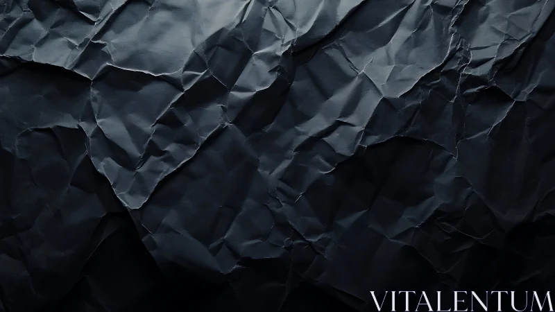 Dark crumpled paper texture under soft directional light.