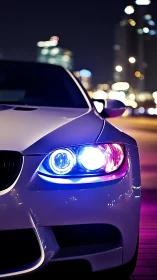 Night urban coupe close-up with neon headlight accents.