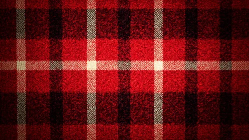 Warm red tartan fabric pattern under vignette lighting.