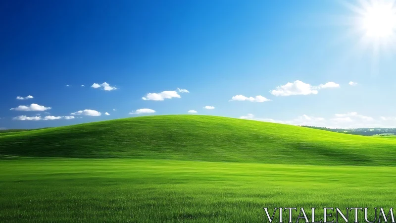 Grassy hillside under clear blue sky with scattered clouds.