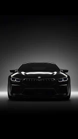 Front view of black performance coupe in studio lighting.