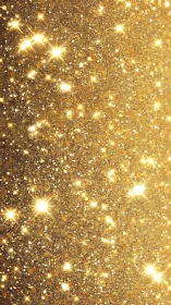 Golden glitter surface scatters warm luminous starbursts