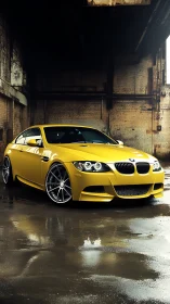 Yellow BMW coupe with wet-surface reflections in decayed warehouse