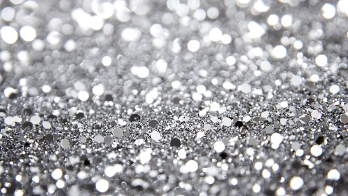 Silver glitter bokeh sparkles in a dreamy, festive blur