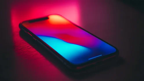Smartphone with neon luminescence gradient across display surface.