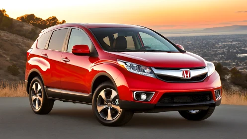 Red Honda SUV parked on roadside at sunset landscape.