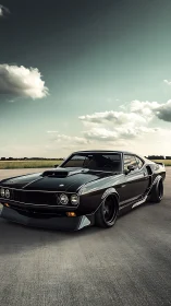 Black muscle car rests on open airfield at sunset.