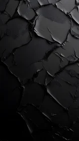 Textured black abstract surface with layered dark shapes.