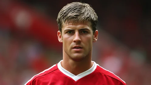 Focused footballer framed by soft stadium blur.