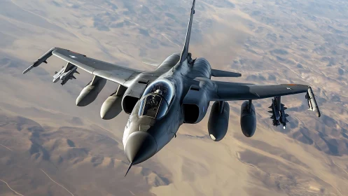 Tactical jet aircraft gliding over arid desert terrain.