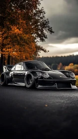 Black widebody sports car parked on road in autumn light.