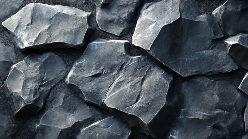 Realistic dark stone wall texture with rugged, angular rocks.