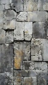 Weathered stone wall with softly fading gray textures.