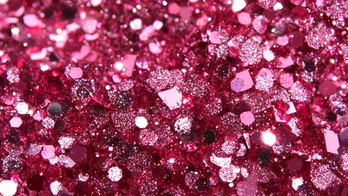 Shimmering pink glitter close up with joyful sparkling light.