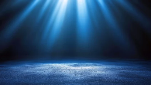 Blue stage floor illuminated by overhead spotlights at night.