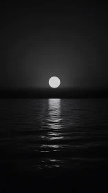 Silent monochrome moonrise washes silver light over water