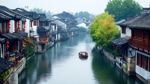 Peaceful canal boat gliding through a misty old town.