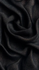 Midnight fabric folds with soft shimmering golden threads.