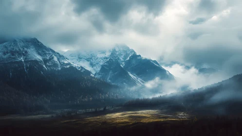 Storm-lit alpine mountains rise through brooding morning mist