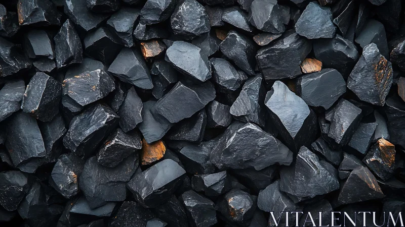 Coal stones in tight textured pile with subtle orange flecks.
