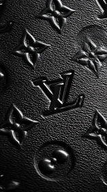 Embossed black leather monogram with glossy central logo.