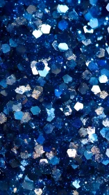 Cobalt blue glitter macro with hexagonal reflective particles.