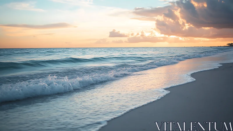 Coastal shoreline captures low surf under layered sunset sky