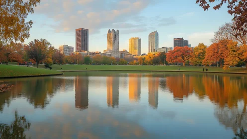 Urban skyline reflects across calm park lake at sunset