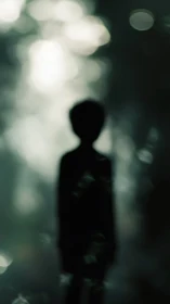 Silhouetted figure dissolves into soft green forest bokeh.