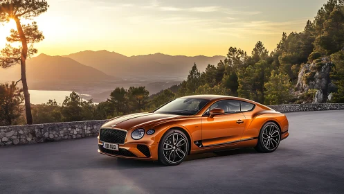 Sunset drive with a glowing orange grand tourer coupe.