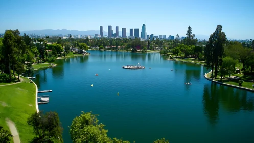City lake reflects skyline under clear midday blue sky