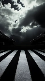 Striped stadium field under overcast dramatic clouded sky.