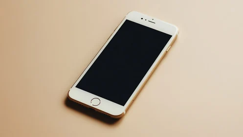 Apple iPhone 5S White Device on Neutral Tan Background.