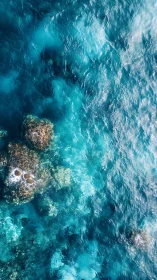 Overhead coastal water shows submerged rocks and wave motion