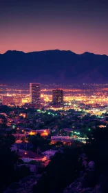 Urban skyline against mountain range at twilight period.